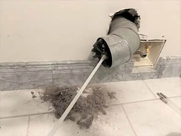 Rotating brush removing heavy dust and debris from air duct vent in Everett WA